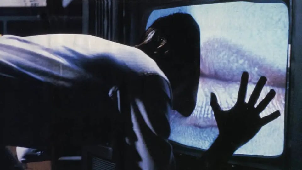 James Woods goes full-immersion as he pushes his head into a TV screen showing Debbie Harry's lips, in Videodrome.