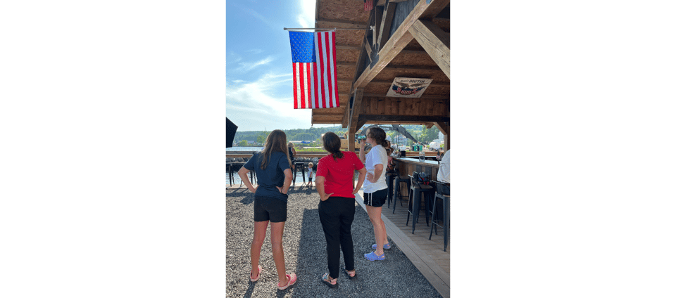 Katy and daughters looking at an American flag