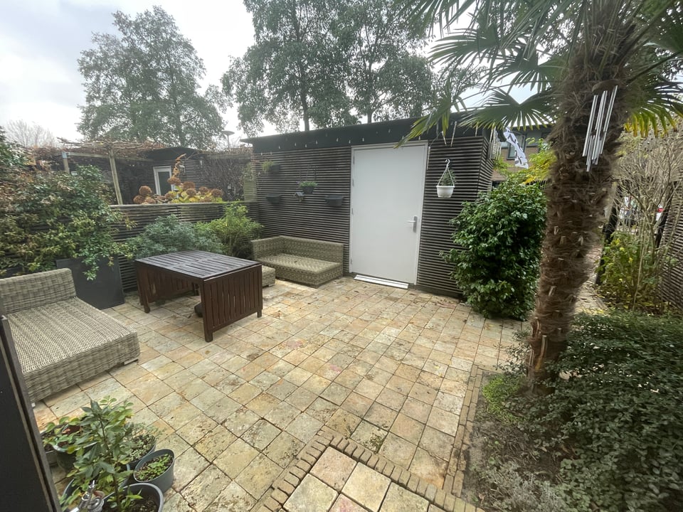 Front patio with power washed beige tiles that are cleaner than before, but not sparkling. But they look pretty good.