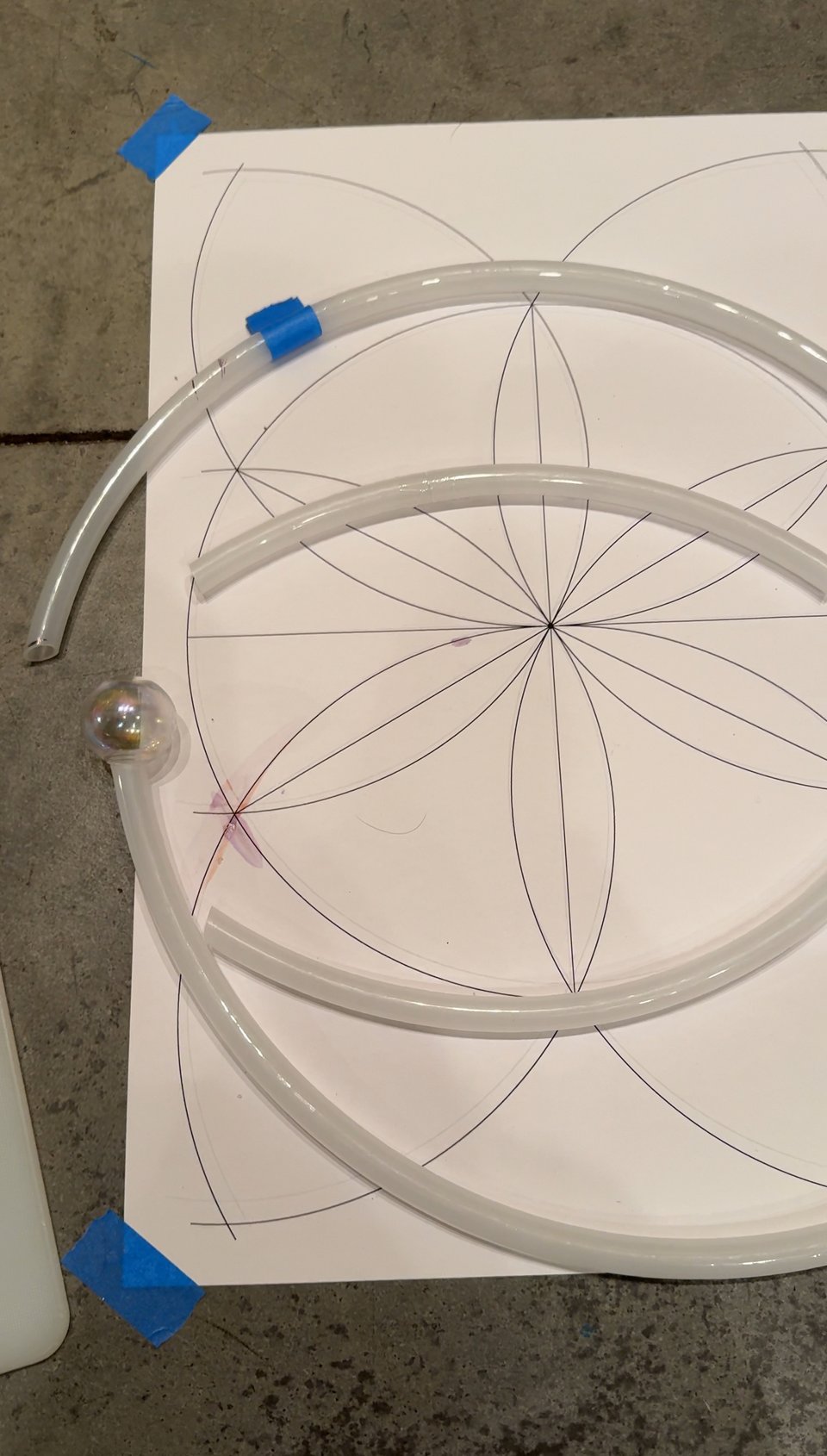 Sections of tubing on floor with template