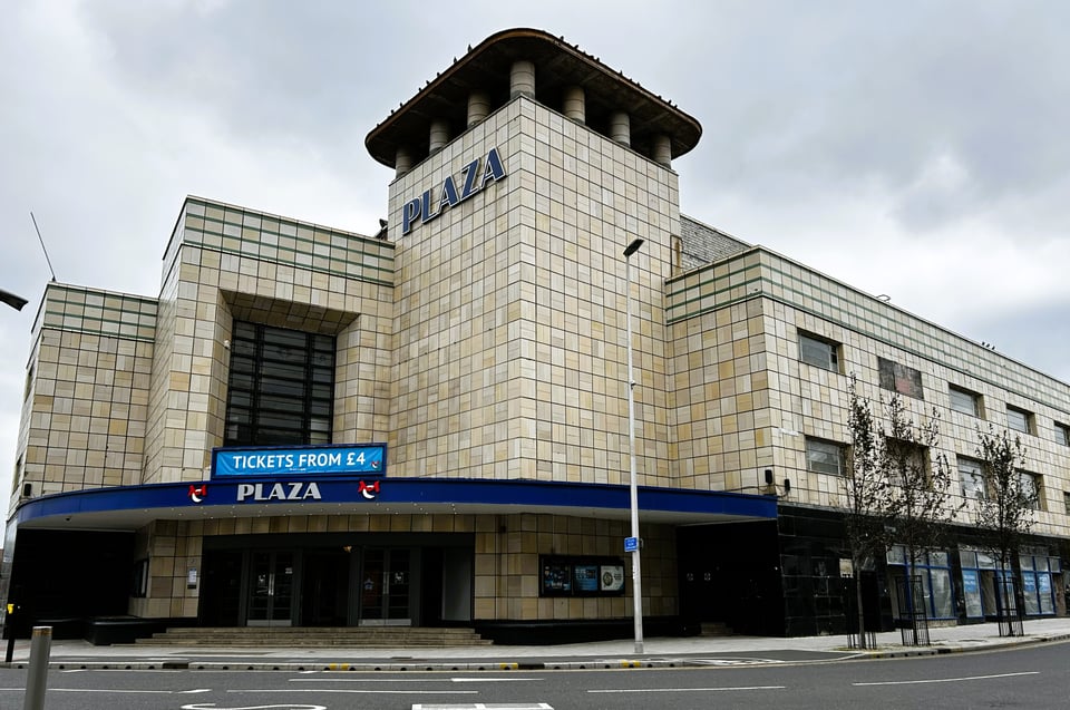 A simply huge, hulking great cinema. It's made of several large masses, including a tower, and is entirely clad in cream tiles.