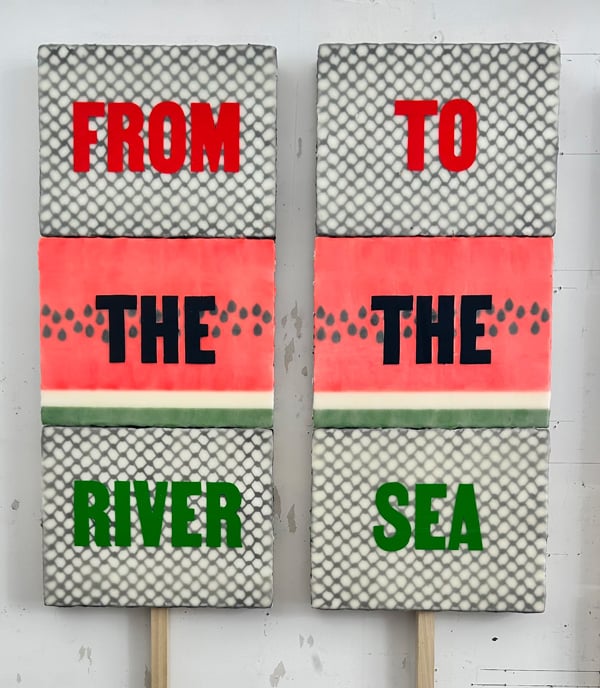 Two signs. The left one says FROM THE RIVER, the right one says TO THE SEA.