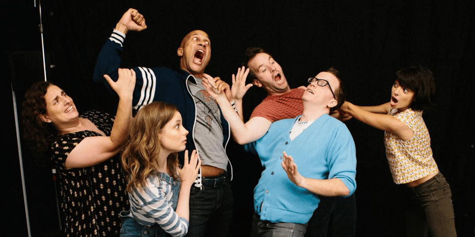 A group of improvisers having a stage fight.