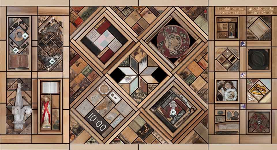 A mixed media artwork made of wood and found objects that looks like blocks of a quilt