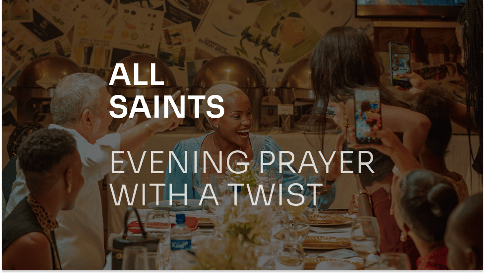 A diverse group of peple gather and laugh around a dinner table