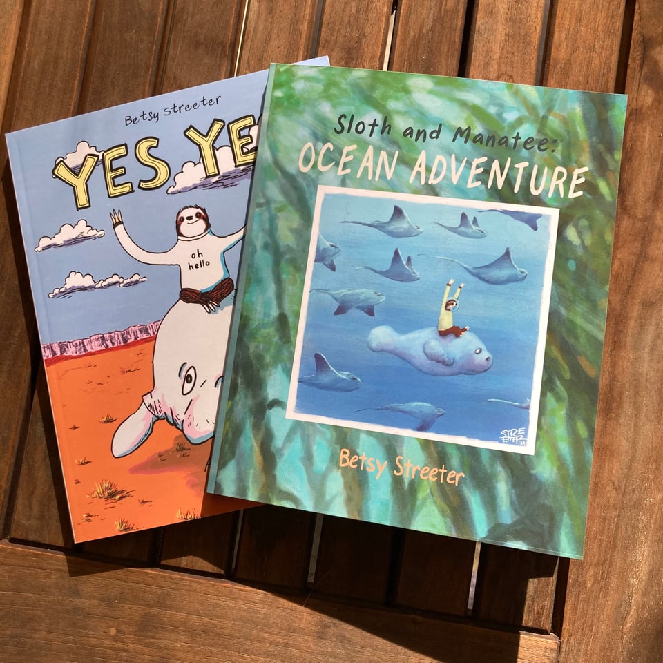 Photo of the two Sloth and Manatee comic books