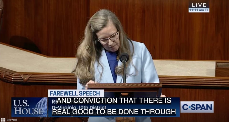 A photo of a middle-aged blonde woman standing at a lectern in the US House of Representatives, with her head tilted down towards the lecturn. She has long hair and is wearing a white suit jacket over a blue thin sweater, and has glasses. Text on screen reads "farewell speech", and there is close captioning with the following words: "and conviction that there is real good to be done through". A station identifier the far lower right side of the screen shows that the broadcast is from C-SPAN