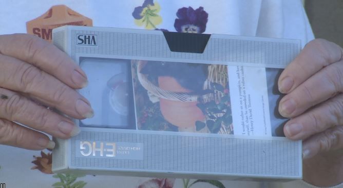 [A close-up of Dawna Kerney’s hands holding the VHS tape she found.]