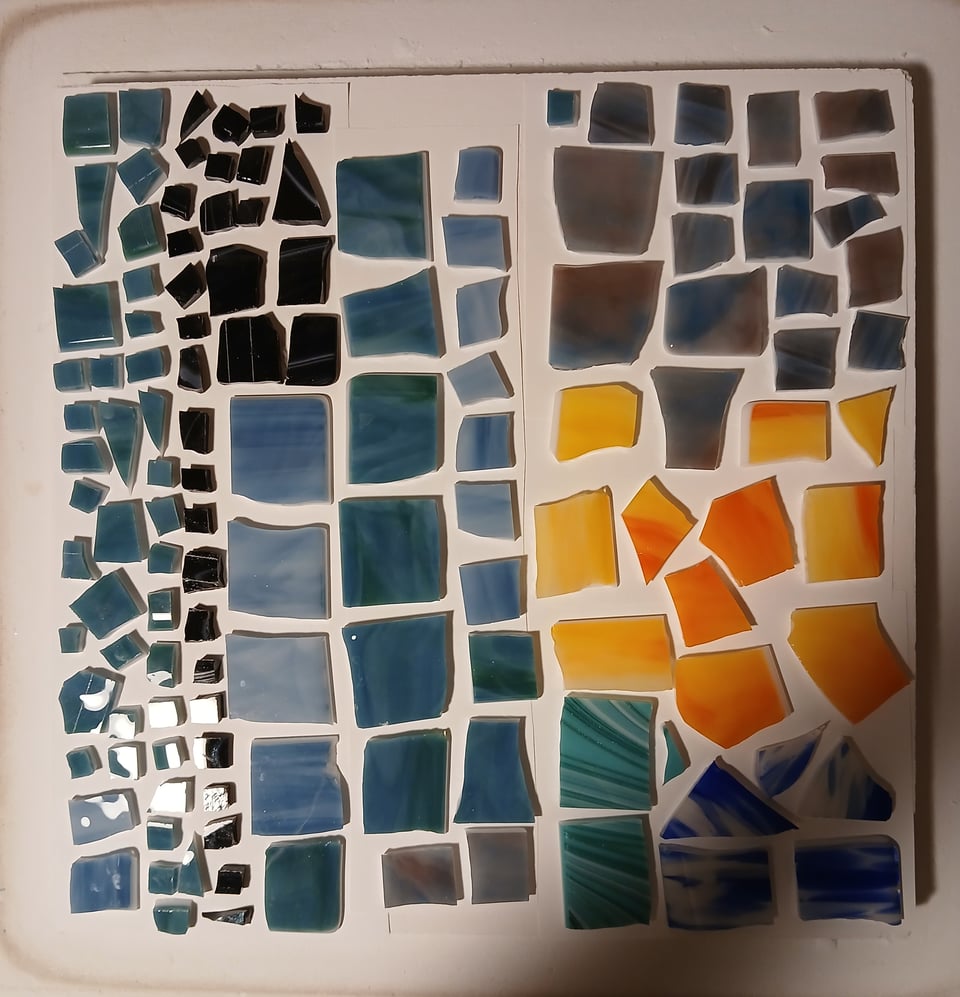 kiln shelf with chopped up glass in blue/green , blue, teal, blue/white, yellow/blue and orange/yellow