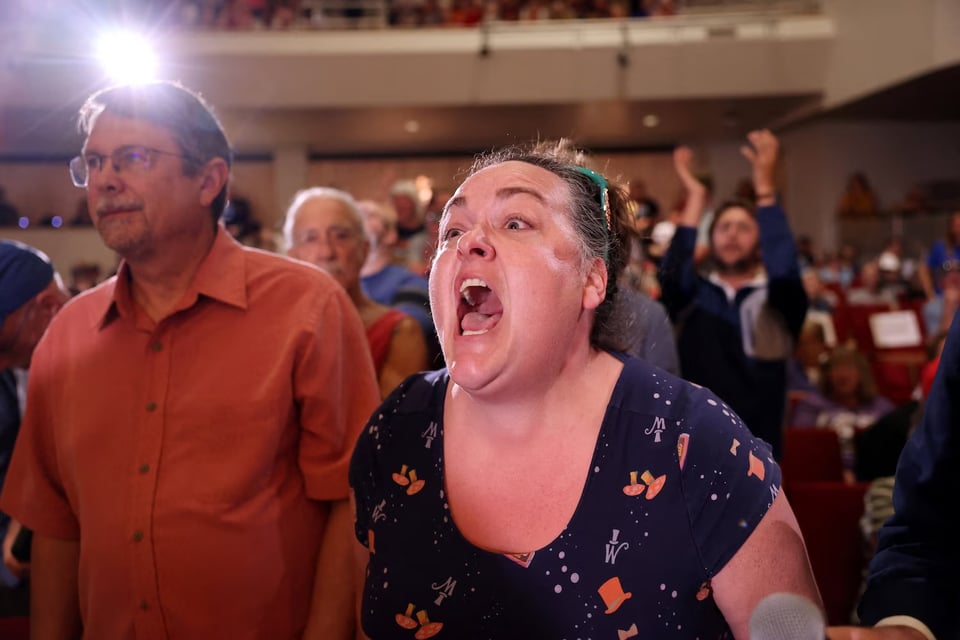 Sarah Davis of Lincoln, Nebraska, shouts after asking U.S. Representative Mike Flood a question during a town hall in Lincoln, Nebraska, U.S., August 4, 2025.