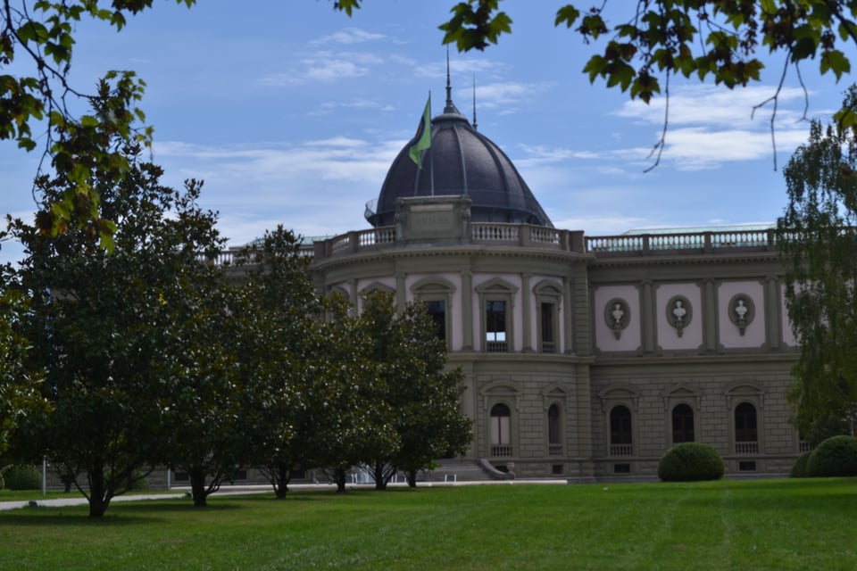 A palace-like building with a central dome and ornate brickwork.