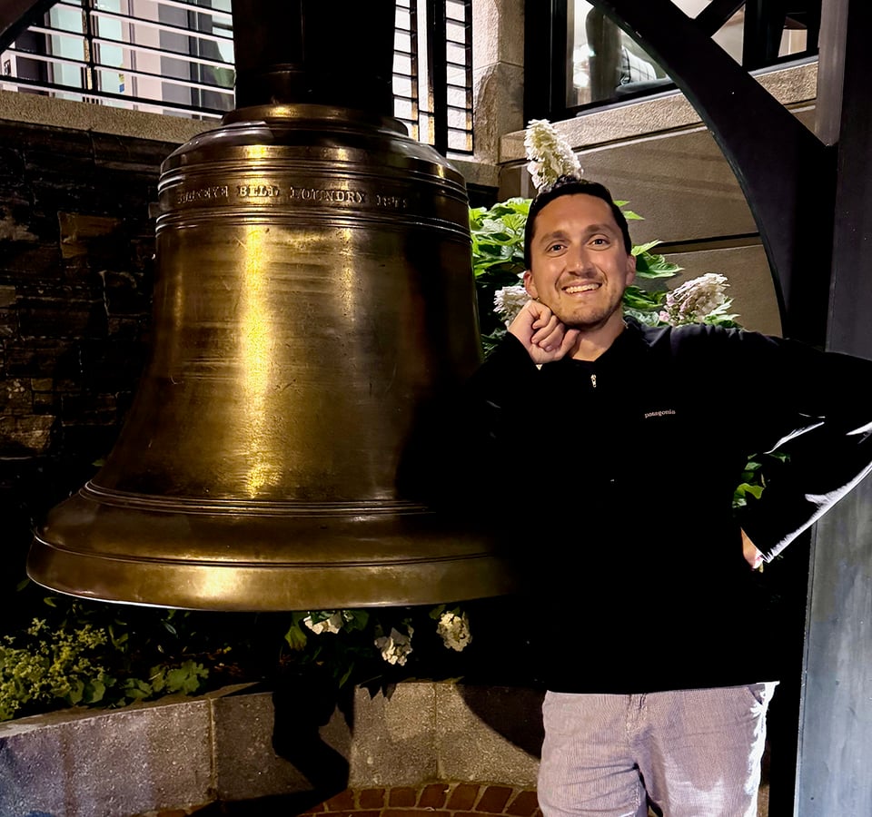 A photo of the author next to a bell.
