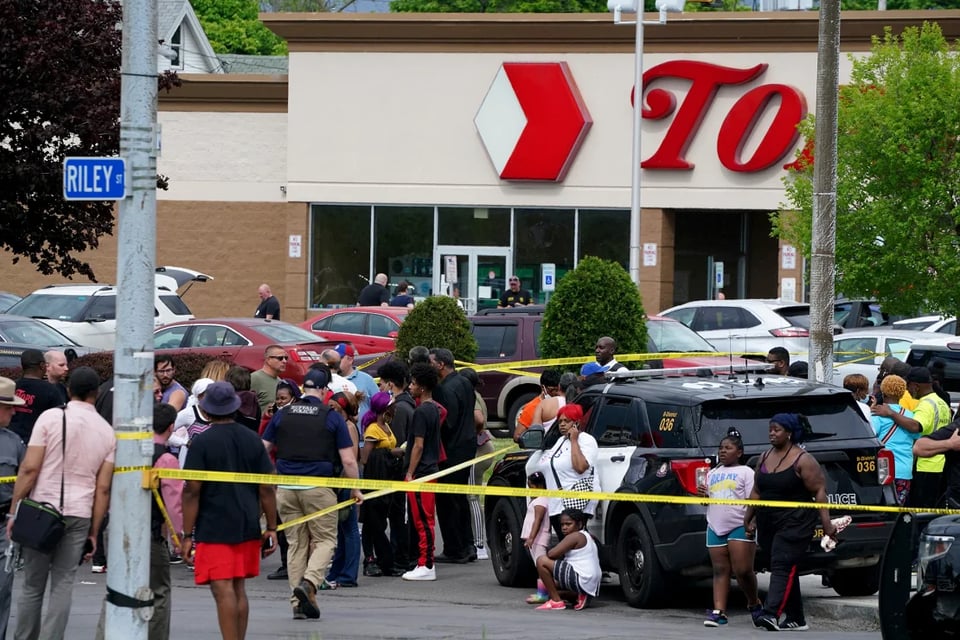 People gather outside a supermarket in Buffalo, New York, where 10 people were killed on Saturday. Derek Gee/The Buffalo News/AP