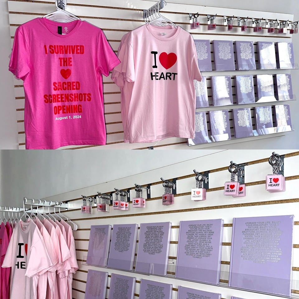Two types of T-shirts and several books and keychains line a wall.