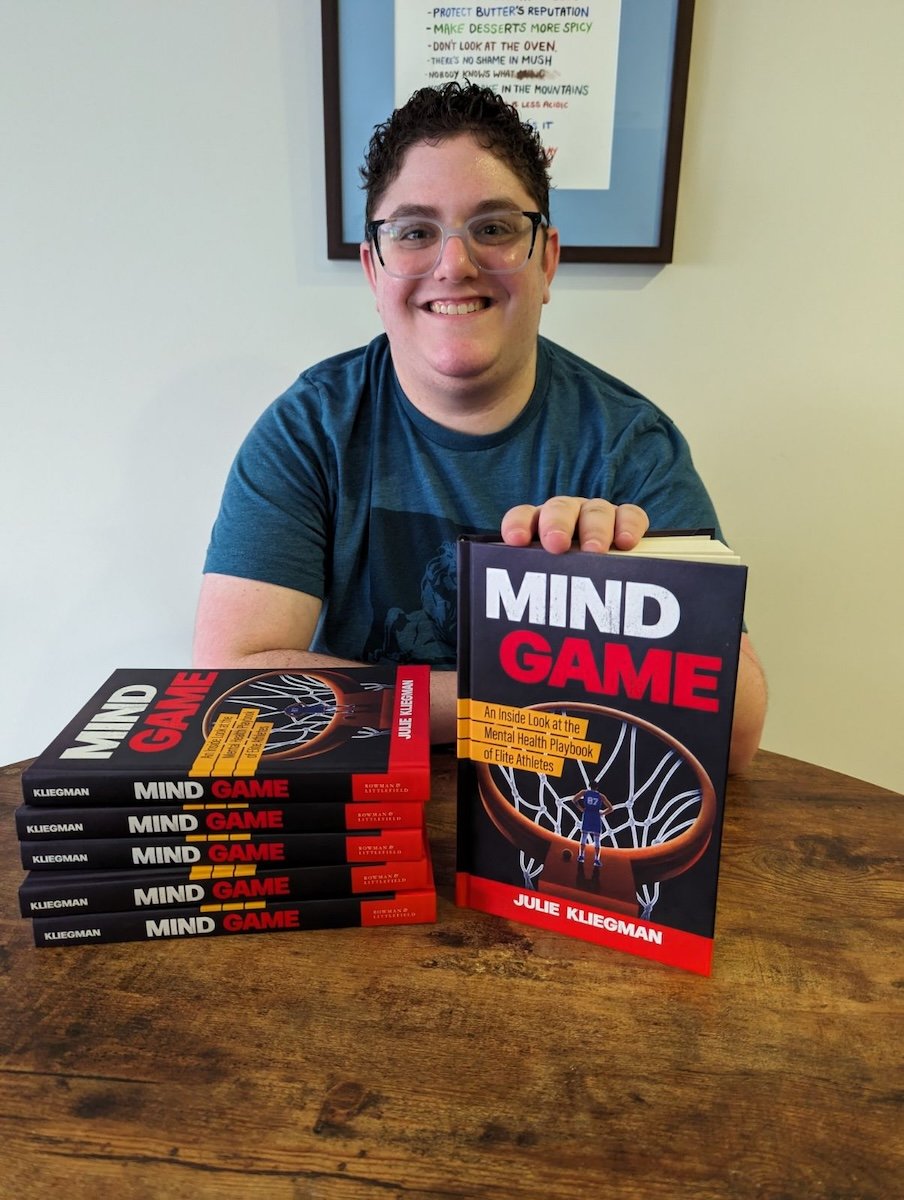 Me with a stack of Mind Game books