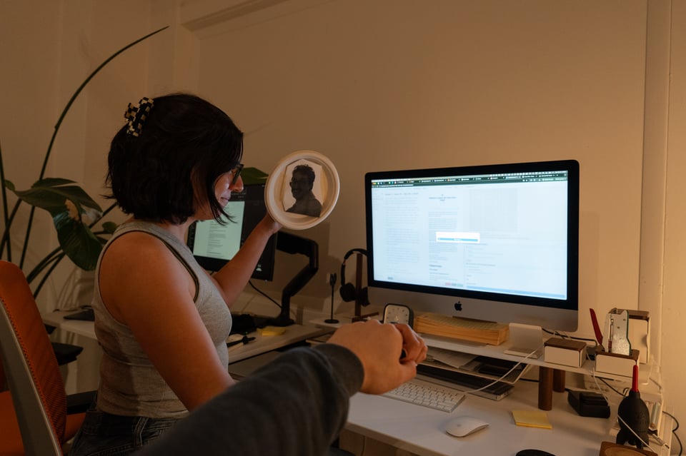 Michelle holding an effigy while sending a newsletter.