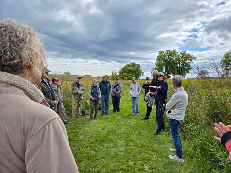 An enthusiastic gaggle of good folks with great questions turned out for the FSPA-sponsored walk/talk with “Sea of Grass: The Conquest, Ruin, and Redemption of Nature on the American Prairie” authors Dave Hage and Josephine Marcotty (right in photo) on Sept. 6. / Photo by Pamela Miller