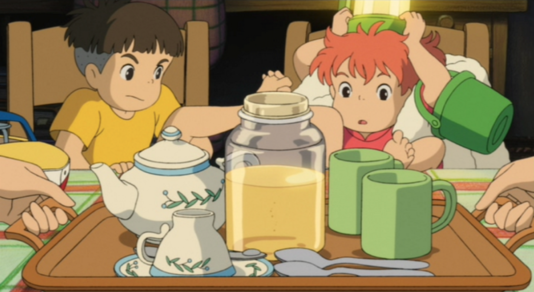 Screencap from Hayao Miyazaki's animated film, Ponyo, depicting the two main characters, Sosuke and Ponyo, playing footsie in front of a tray of tea and honey.