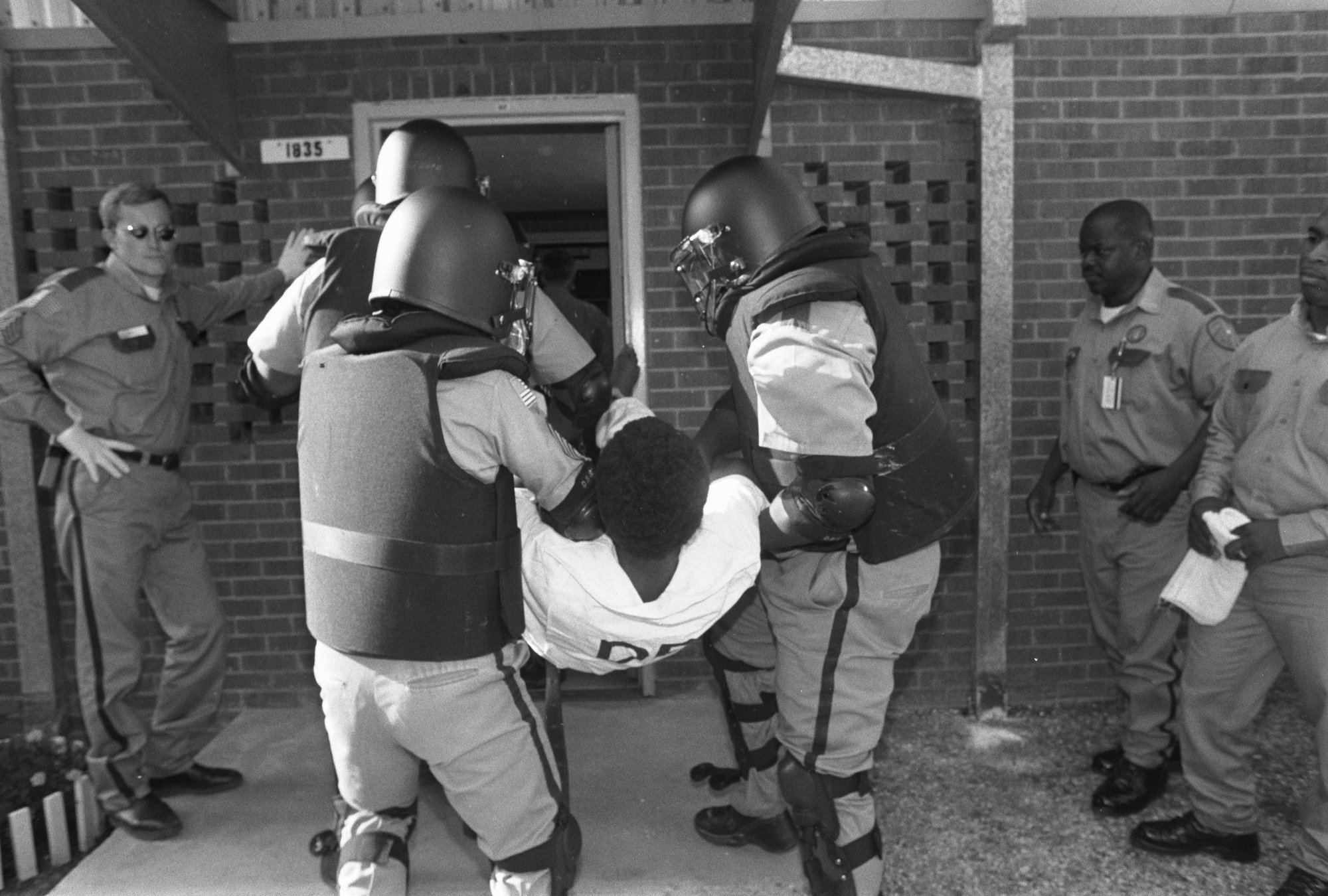 A cell-extraction team carries Gary Graham (Shaka Sankofa) into the Death House at the Huntsville Unit before his execution.