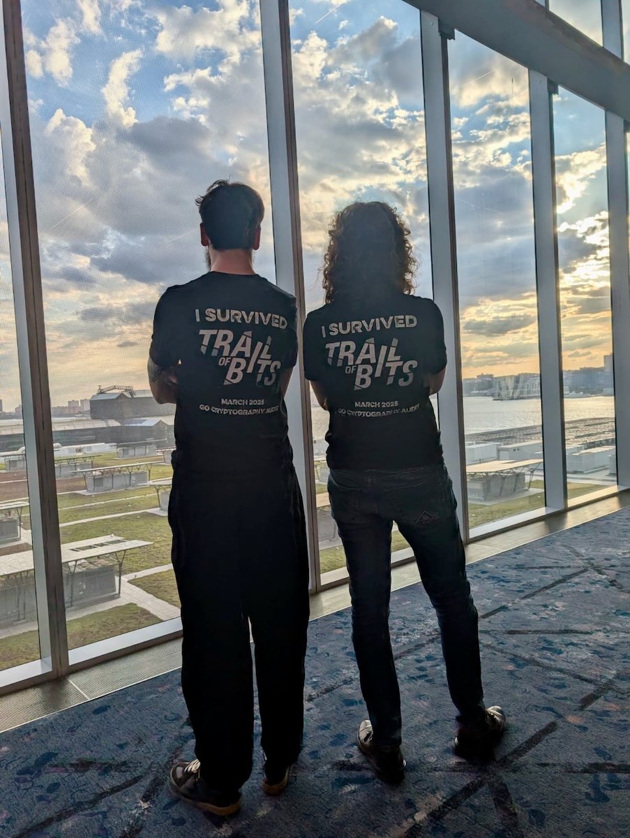 Roland and I showing off I SURVIVED TRAIL OF BITS t-shirts