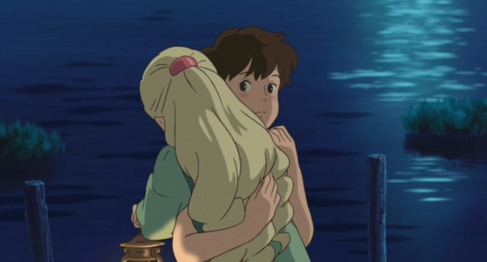 Anna and Marnie hug. Anna's uncomfortable expression is visible.