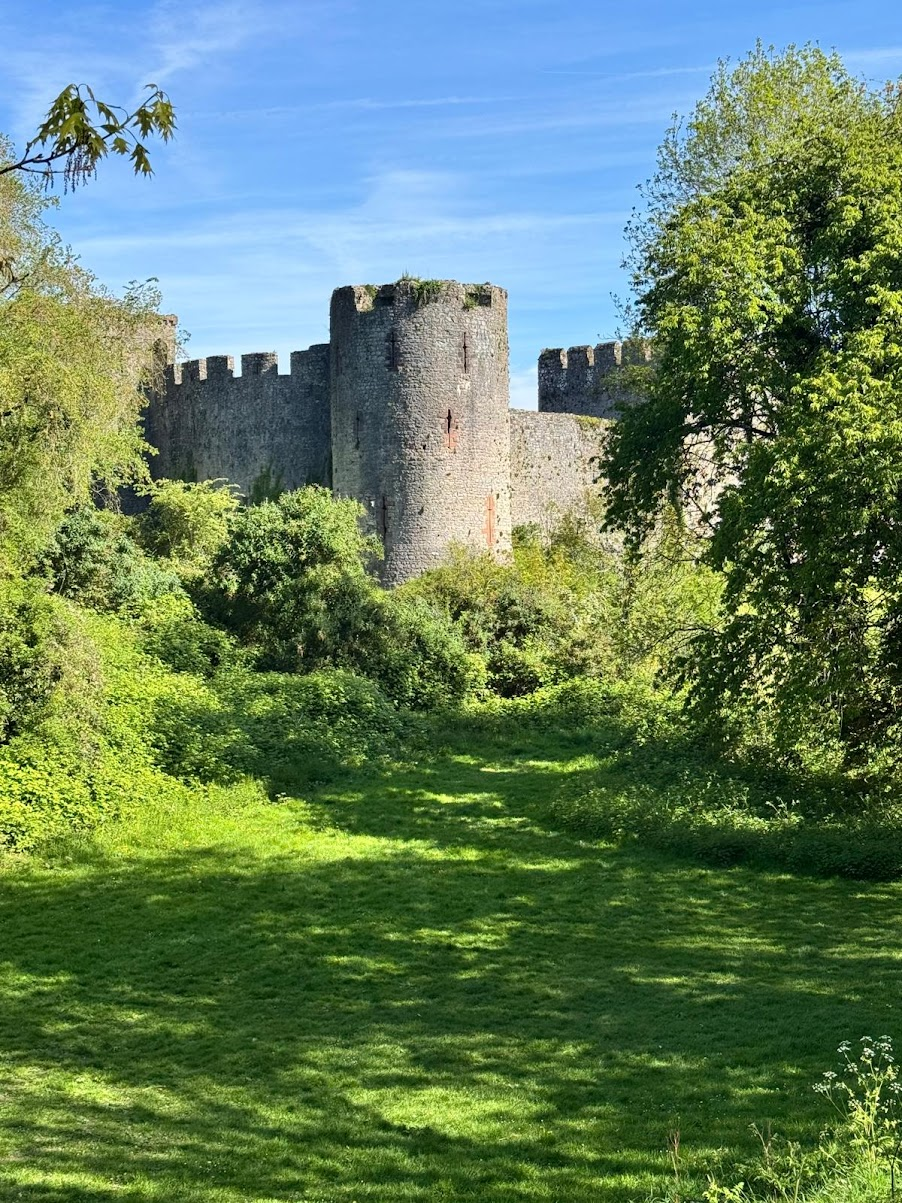Chepstow Castle, as seen through the grounds in front of it on a lovely sunny day