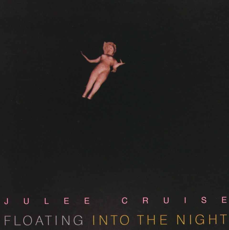A blurry image of a naked pink Barbie-like doll, apparently floating in pure darkness. The doll is somewhat small compared to amount of darkness around it, as if it is being engulfed by the darkness. Would it surprise you to know David Lynch shot this? It shouldn't.