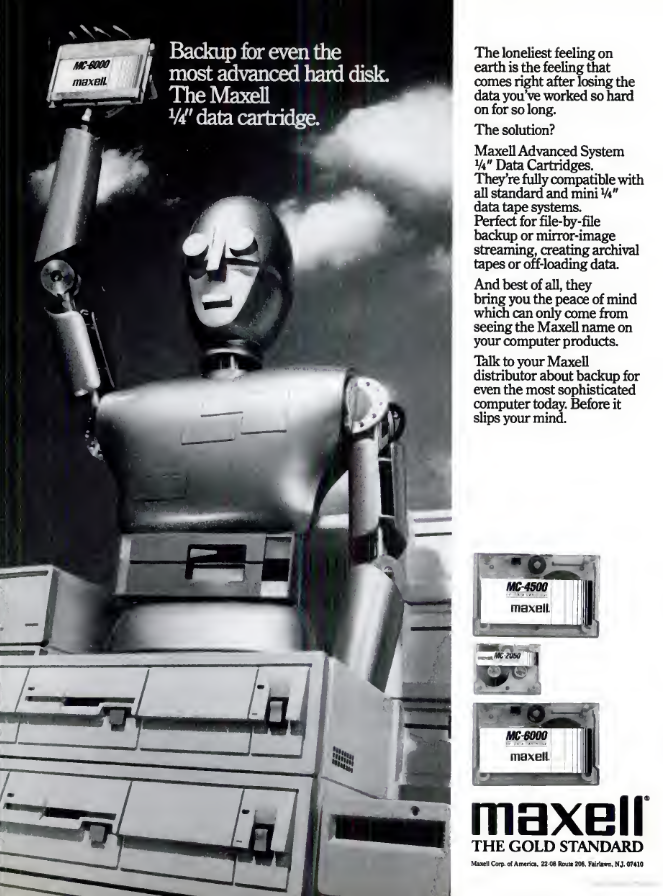 A black-and-white photo of a robot standing amidst computer hardware. The robot is holding a data backup tape high above its head and there's a cloud sky in the background.
