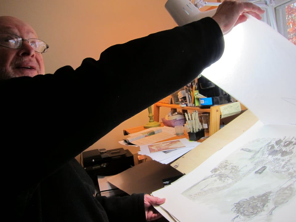 Jules Feiffer showing off a page of his artwork in 2014