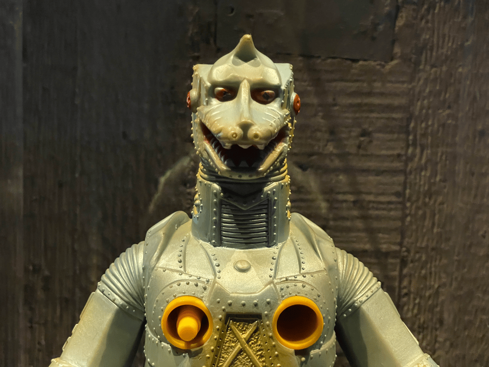 A close-up of a toy robot lizard's face