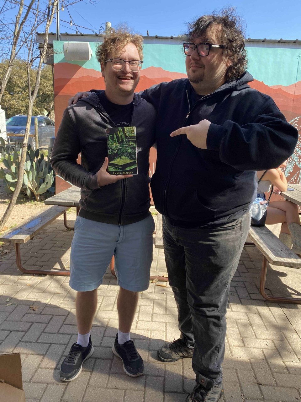 two people holding a book