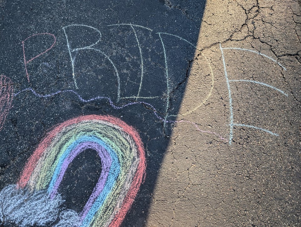 Chalk art:
PRIDE written over a rainbow