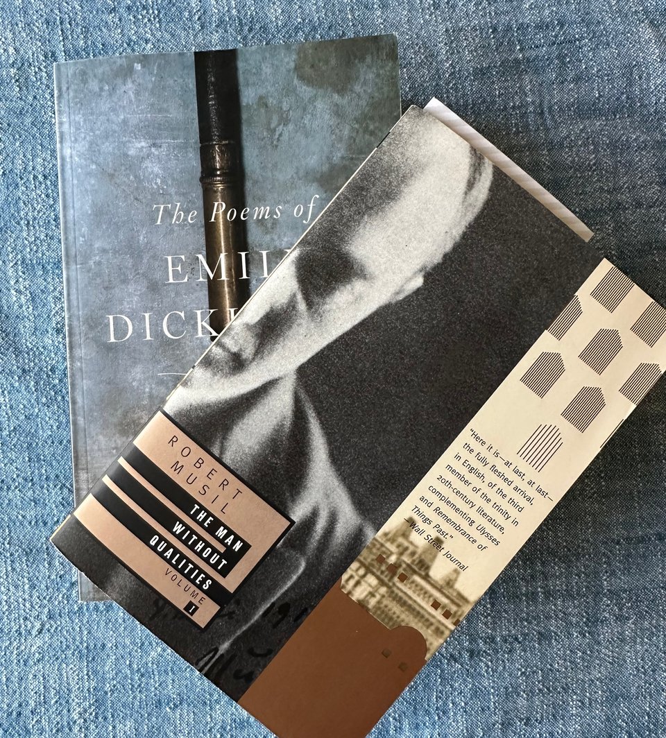 photo of two books on a chambray tablecloth: The Poems of Emily Dickinson and The Man Without Qualities