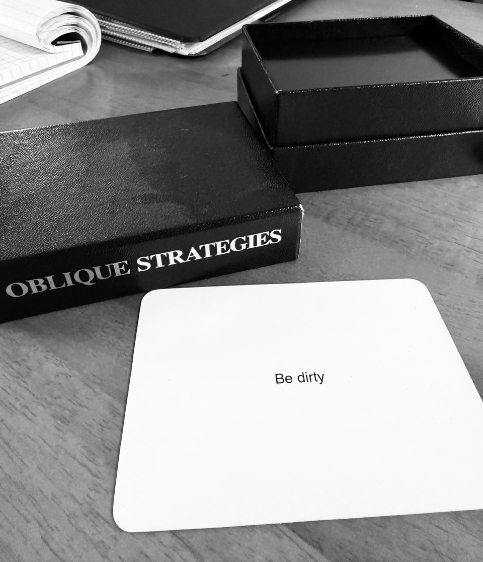 b/w photo of an Oblique Strategies card and the box from which it was drawn; the card reads, "Be dirty"