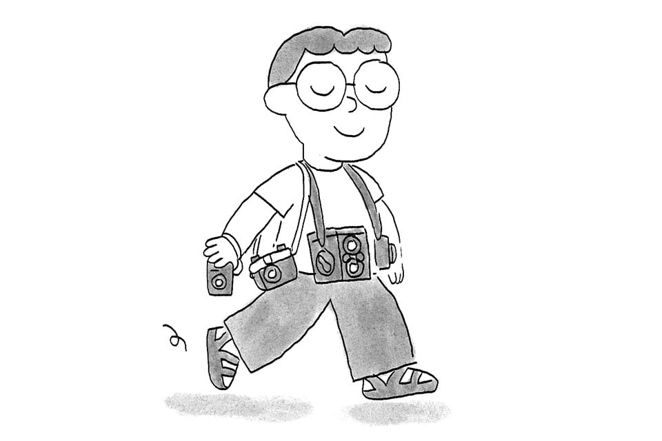 Dibujo de una persona llevando demasiadas cámaras colgadas.
Drawing of a person carrying too many cameras around their neck.