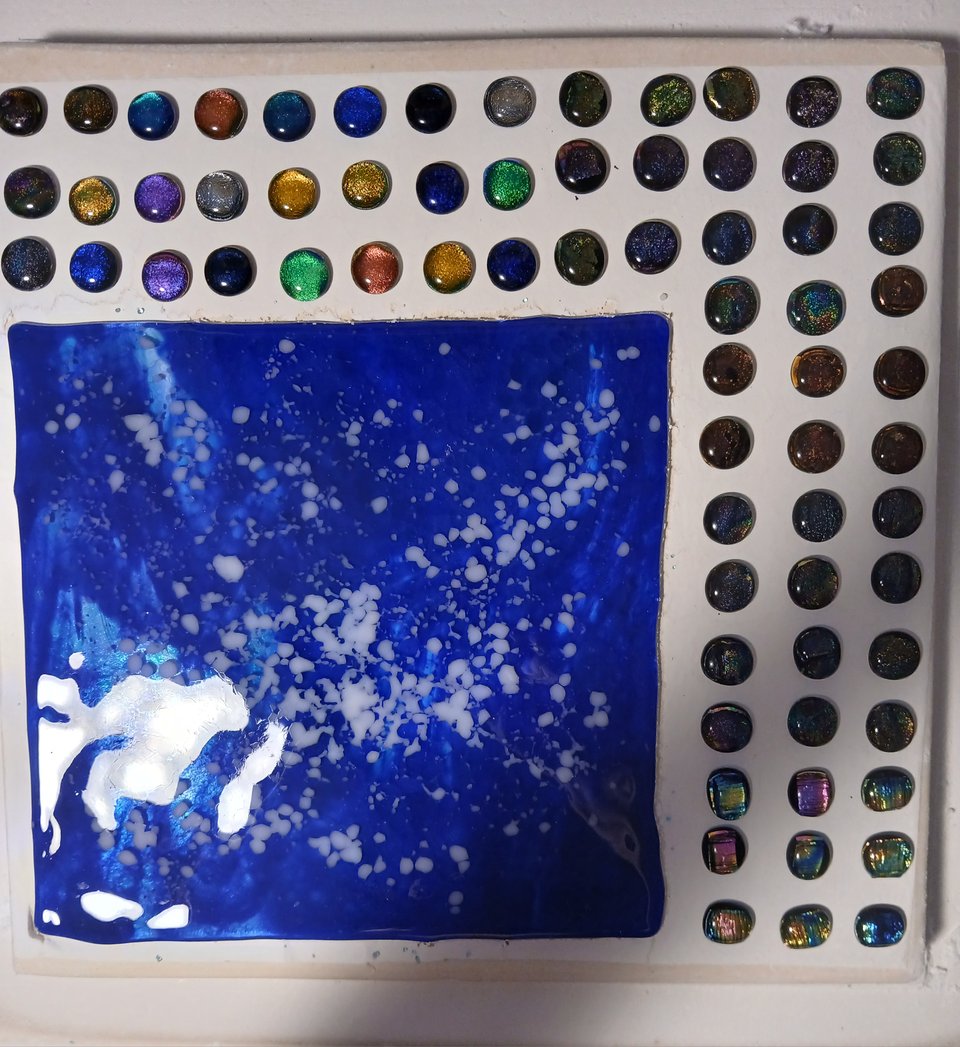 the sheet has melted down, it looks like there's sea foam on it. the dichroics have fused into cabochons