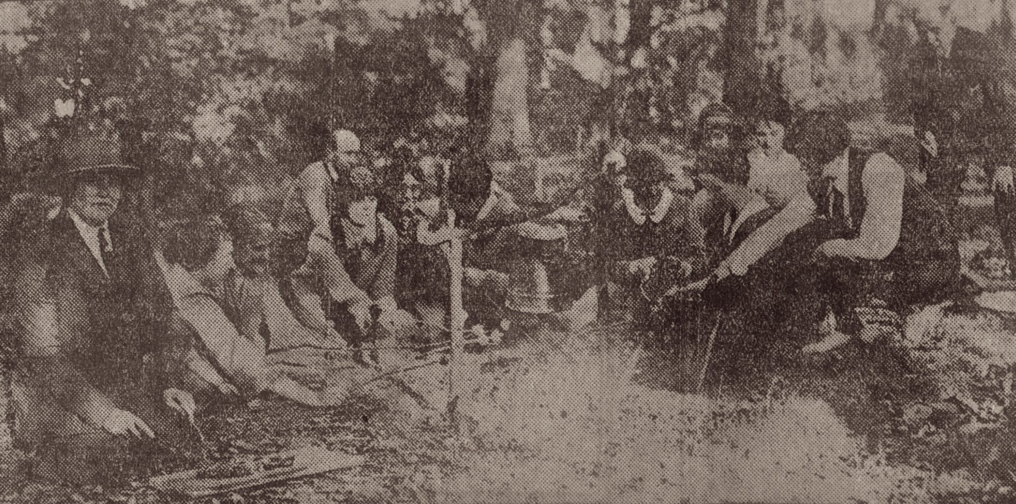 Girl Scouts leaders toast marshmallows in an archival image from 1924