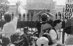A vintage black and white image shows protestors throwing ashes on the White House lawn