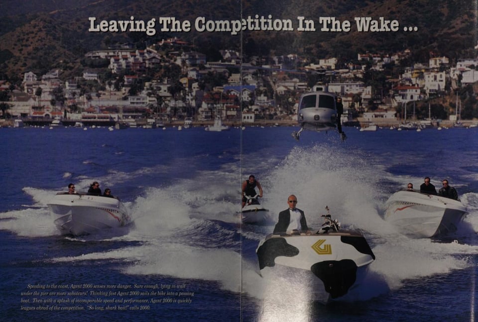 Ted Waitt, CEO of Gateway 2000 is driving a boat painted with cow spots (there's also a spotted motorcycle in the boat) while being pursued by two other boats, a jetskit, and a helicopter, parodying a James Bond scene.
