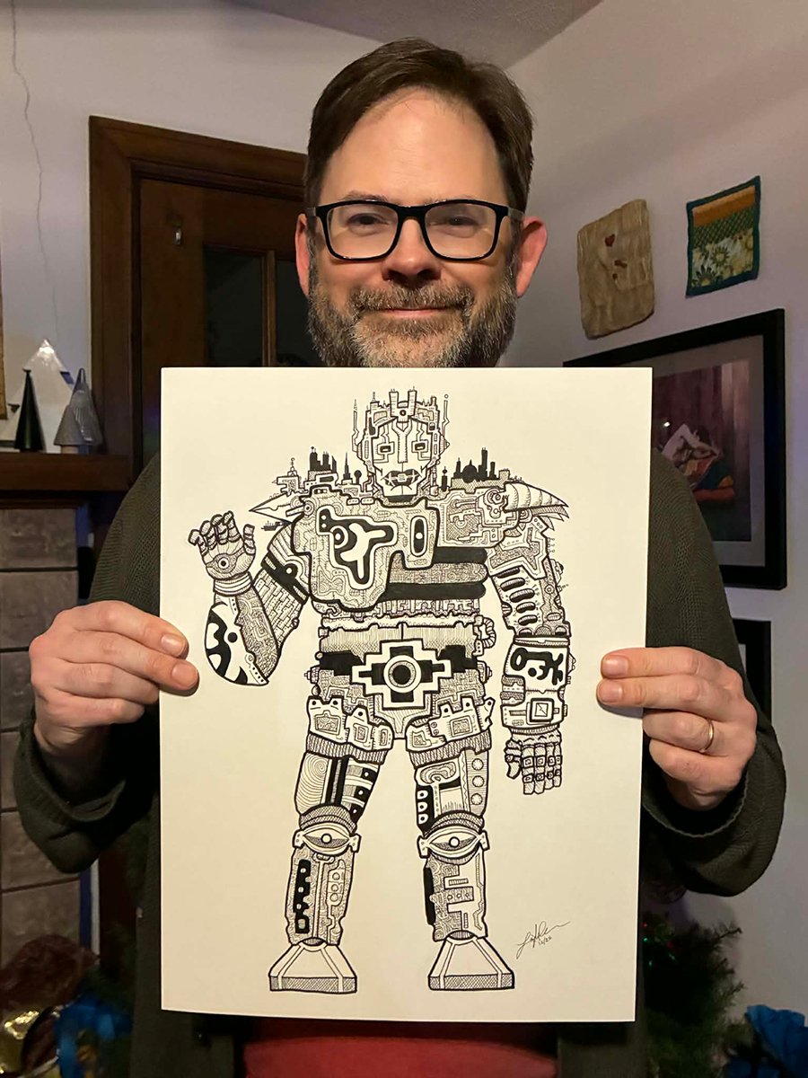 This is photo of me, Leighton Connor, holding up the aforementioned robot drawing so you can see how big it is. It covers everything from my chin to my waist.