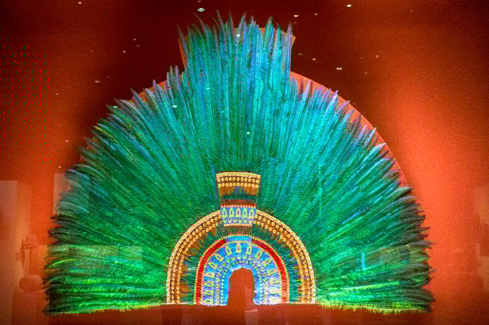 The replica of a headdress made of green quetzal feathers.