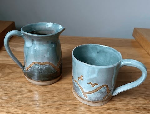 Two blue pottery mugs