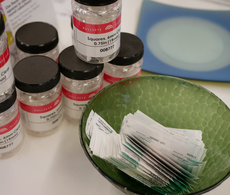 jars of glass squares next to a glass bowl full of handy band-aids