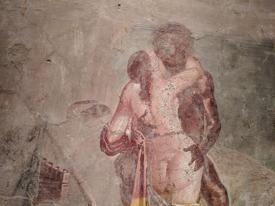 A woman and a man kissing. THey are very faded and messed up.