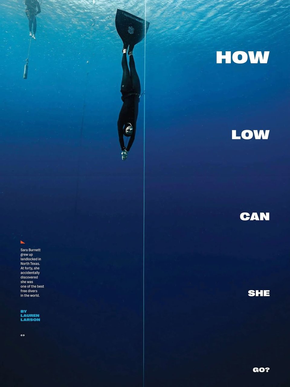 The cover of Texas Monthly magazine, showing a freediver in a black wetsuit and monofin descends vertically into deep blue ocean water. She is following a guideline that stretches from the surface into the depths. The diver is perfectly streamlined, hands pointed downward, surrounded by the tranquil, gradient blue of open sea. Another diver or support person floats in the background. Bold white text aligned vertically on the right reads: “HOW LOW CAN SHE GO?” On the left, a short caption introduces Sara Burnett, who grew up landlocked in North Texas and discovered at age forty that she was one of the best free divers in the world. The piece is by Lauren Larson, and the page number “69” appears at the bottom. The composition emphasizes serenity, isolation, and the physical challenge of freediving.