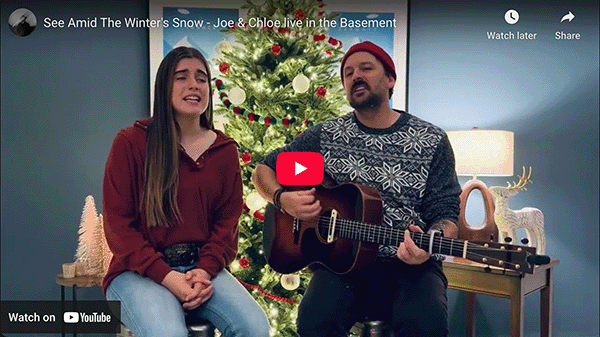 Poster image of the YouTube video showing Joe and Chloe singing in front of a Christmas tree