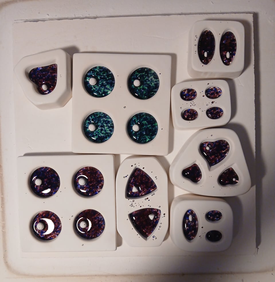the pieces have melted and fused and are very shiny and also pink, blue and purple, except one set of blue-green