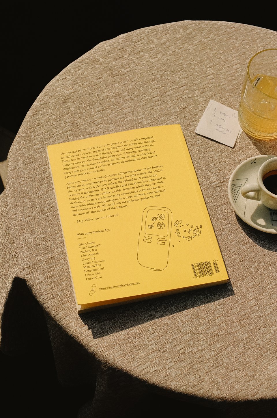 [A shot of the phone book laying on the table with the back cover visible.]