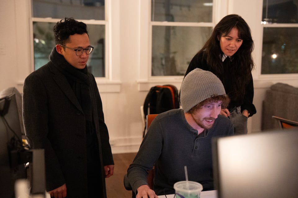 People looking intently at a screen.