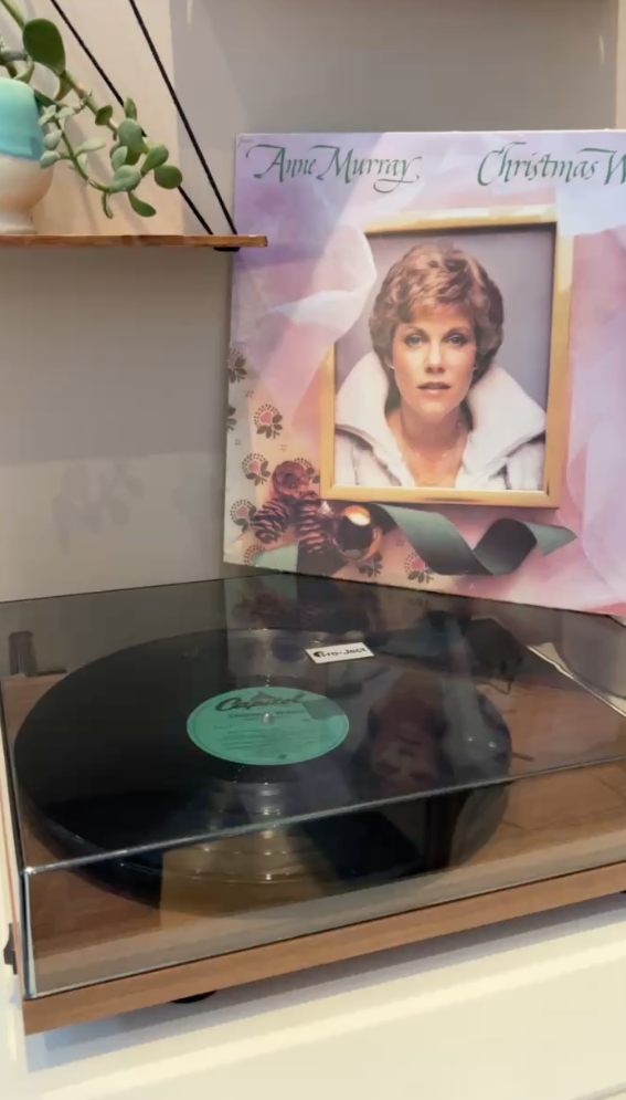 Photo of a record player with an album for Anne Murray Christmas sitting on top of it.